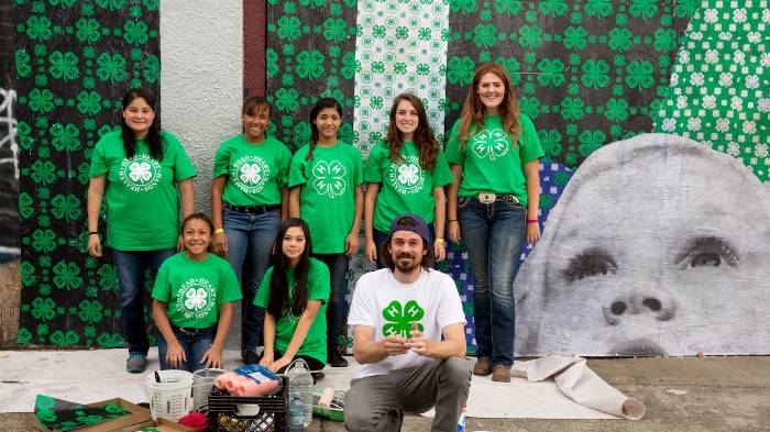group of 4-H youth in front of brick wall